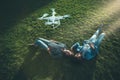 Black and Caucasian girl on the grass, flying UAV above