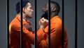 Black and caucasian prisoners having fight in cell, jail overcrowding, conflict Royalty Free Stock Photo