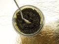 Black caviar, luxurious delicacy on golden background Royalty Free Stock Photo