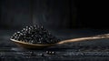 Black Caviar in an Ornate Spoon on a Dark Wooden Surface Royalty Free Stock Photo