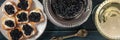 Black caviar panorama, overhead flat lay shot. Caviar on toasts and in a vintage bowl, with champagne Royalty Free Stock Photo