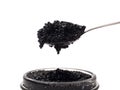 Black caviar in spoon above jar Royalty Free Stock Photo