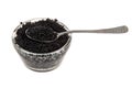 Black caviar and spoon, isolated on white