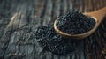 Black Caviar in a Wooden Spoon on a Rustic Wooden Surface Royalty Free Stock Photo