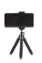 black cellphone in rugged rubber protective cover on small flexible tripod isolated on white