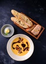 Black ceramic bowl of pumpkin cream soup with balsamic sauce, served pumpkin soup on a dark background Royalty Free Stock Photo