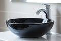 Black ceramic round sink and chrome faucets in the bathroom. Minimalist modern bathroom interior design