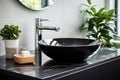 Black ceramic round sink and chrome faucets in the bathroom. Minimalist modern bathroom interior design