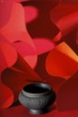 Black ceramic vase on abstract red background Royalty Free Stock Photo