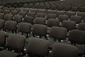 Black chairs in big empty congress room