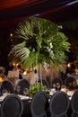 Black chairs with green floral centerpiece at night luxury romantic indoor wedding