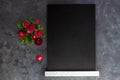 Black chalk board mockup with pink daisy flowers on grey background.Blackboard menu easel,spring sales. Copy space frame Royalty Free Stock Photo