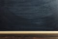 Black chalk board over wooden table, blank for text or background for a school theme