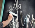 Black chalk Board scribbled little boy colored crayons. Learning the alphabet and preparing for school