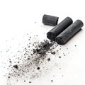 Black Chalk Pieces with Flying Dust Effect Isolated on White Background Royalty Free Stock Photo