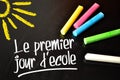 Chalkboard with coloured chalkb and the french words for frist schoolday - le premier jour decole Royalty Free Stock Photo