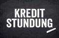 Black chalkboard with german words for deferred payment - kreditstundung Royalty Free Stock Photo