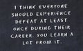 Black chalkboard with handwritten wise motivational quote