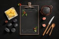 Black chalkboard with a holder with different kitchen items around on a dark gray background, Generative AI