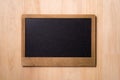 Black chalkboard over wooden table. Blank chalkboard with wood frame, erased and ready for your message Royalty Free Stock Photo