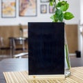 Black chalkboard on a table in a cafe Royalty Free Stock Photo