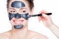 Black charcoal mask application on beautiful woman. Royalty Free Stock Photo