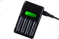 Black charger for charging four batteries Royalty Free Stock Photo