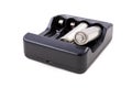 Black charger and silver batteries for energy storage. Accessories for powering household appliances