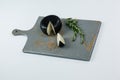 Black cheese with rosemary on chopping board