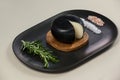 Black cheese with rosemary and salt on serving tray