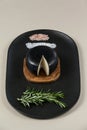 Black cheese with rosemary and salt on serving tray