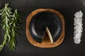 Black cheese with rosemary and salt on serving tray