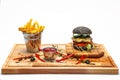 Black cheeseburger with French fries in a bucket Royalty Free Stock Photo