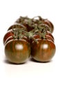 Black cherry tomatoes on white background Royalty Free Stock Photo