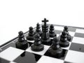 Black chess king stands on a chess board with figures Royalty Free Stock Photo