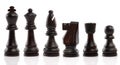 Black chess, standing in a row, isolated on white background. Close-up Royalty Free Stock Photo