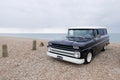 Black 1964 Chevrolet Suburban parked on the beach Royalty Free Stock Photo