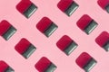 Black chewing gum pads on pink red crimson background