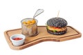 Black chicken burger with cheese balls on cutting board isolated on white background Royalty Free Stock Photo