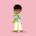 black child holding a toy dinosaur, pink background