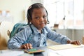 Black child playing home office work with calculator Royalty Free Stock Photo