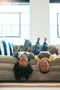 Black children, siblings and relax on living room sofa lying upside down with smile for fun time together at home. Happy Royalty Free Stock Photo