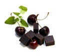 Black chocolate lump and dark large cherry isolated on white