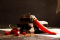 Black chocolate, red pepper on a dark background Royalty Free Stock Photo