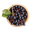 Black chokeberry berries Aronia melanocarpa in wooden bowl isolated on white