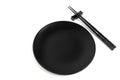 Black chopsticks and black plate on white Royalty Free Stock Photo