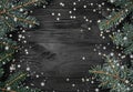 Black Christmas background with fir branches and golden stars, space for text. Top view. Snow effect