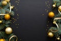 Black Christmas background with golden decorations, baubles, fir tree branches, confetti. Christmas holiday celebration, winter, Royalty Free Stock Photo