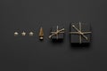 Black Christmas background with golden christmas tree and black gift boxes Royalty Free Stock Photo
