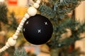 Black Christmas ball with white Xs with other ornaments